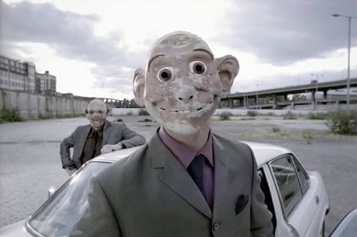 Character From Playstation ad wearing a creepy mask.